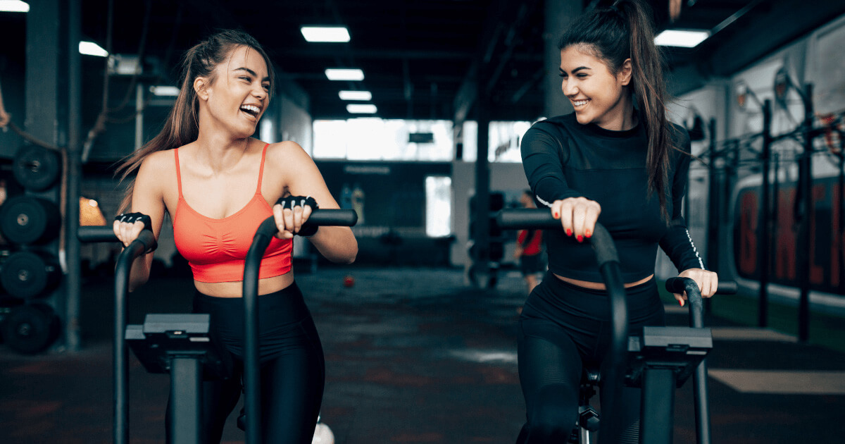 Man and woman high-fiving in a gym